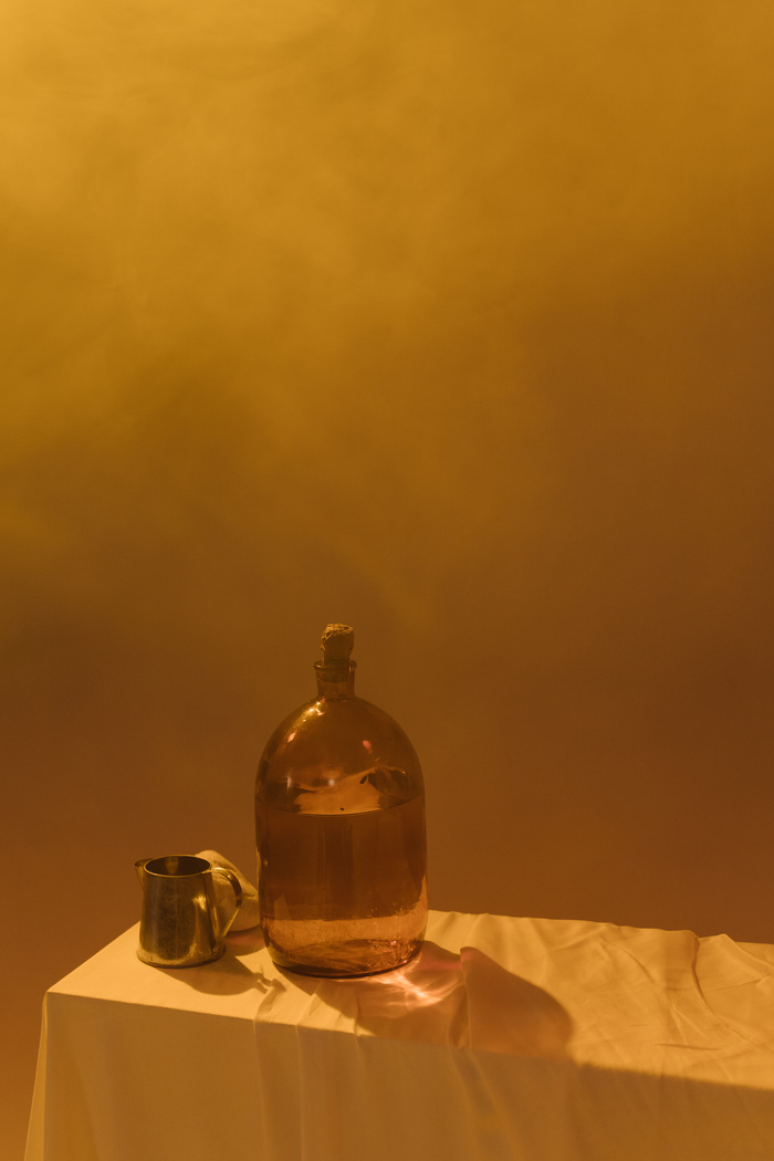 Brown Glass Bottle on White Textile